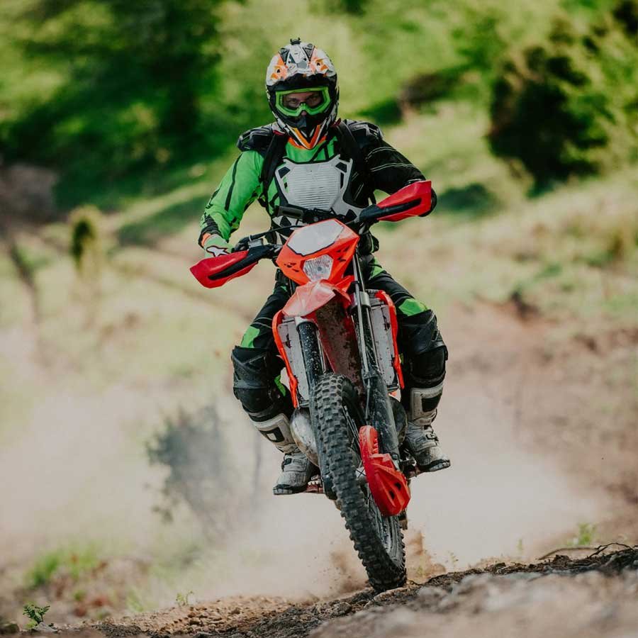 A man riding an enduro motorbike