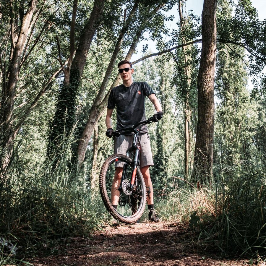A man on a mountain bike in some woodlands