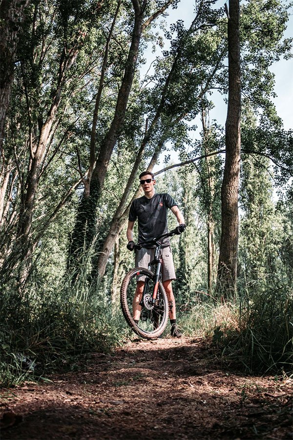 A man on a mountain bike in some woodlands
