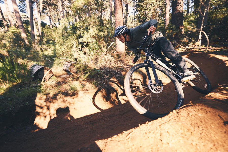 A man on a mountain bike in some woodlands