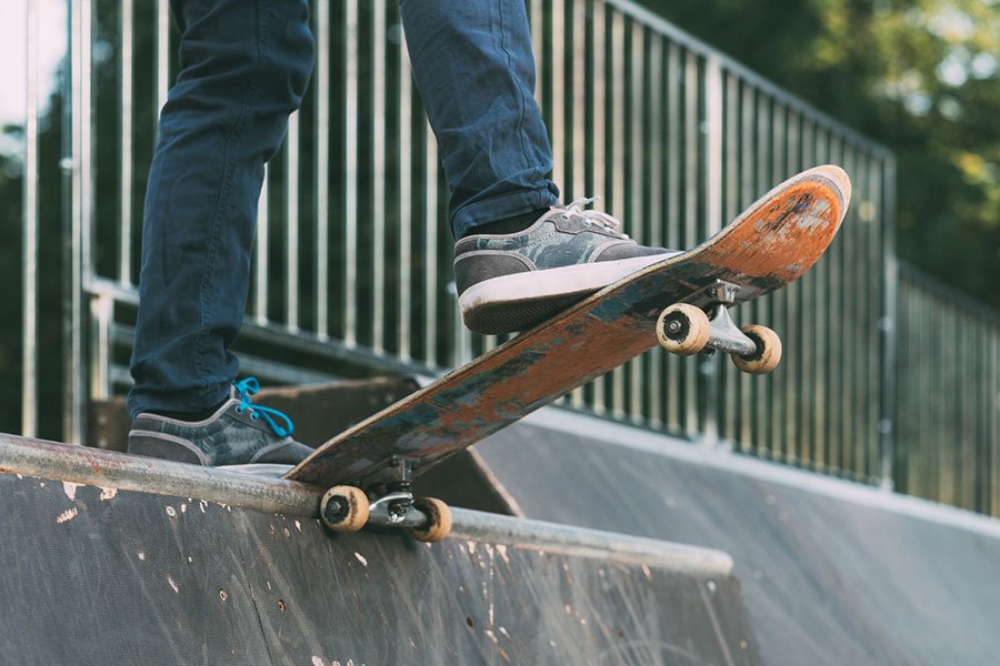 A man on a skateboard getting ready to drop in on a ramp