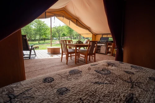Chirps Safari Tent - A view from one of the double beds showing the table, chairs and the open tent
