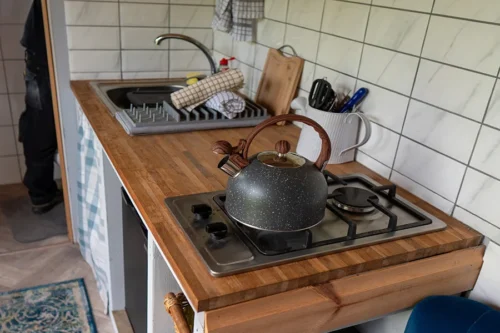 Cwtch Shepherd Hut - Kitchen area with kettle and sink