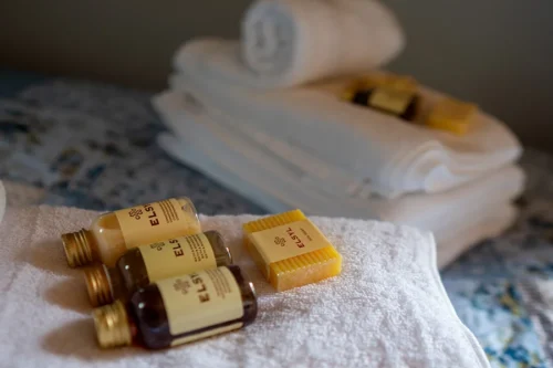 Towels and soaps on a double bed in Cwtch