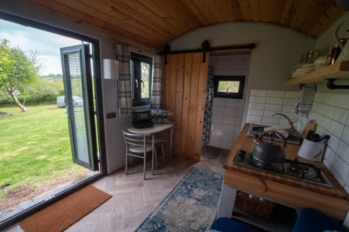 Cwtch Shepherd Hut - Kitchen area with a table