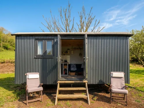 Outside of the Cwtch Shepherd hut with sunshine