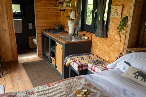 The Nook Shepherd Hut - A view of the kitchen area from the double bed