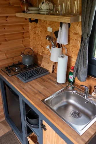 The Nook Shepherd Hut - Kitchen area with sink and cooking facilities