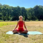 April, a part of our surf & yoga retreat in cornwall, sitting on a yoga mat